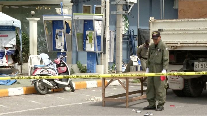 Police Explosive Ordnance Disposal official inspects the site of a bomb blast in Hua Hin