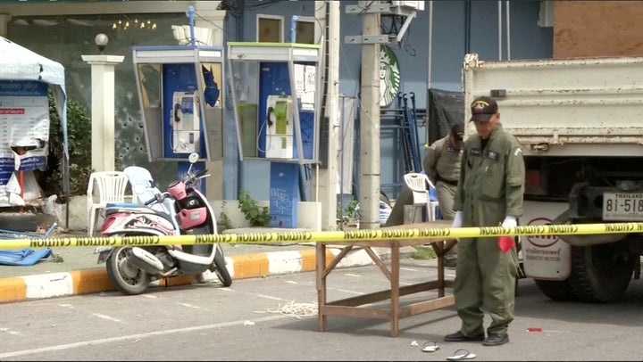 Police Explosive Ordnance Disposal official inspects the site of a bomb blast in Hua Hin