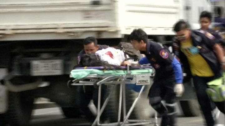 Medics rush an injured person from the scene of the bombing; at least four people died in the bombings and dozens were injured 