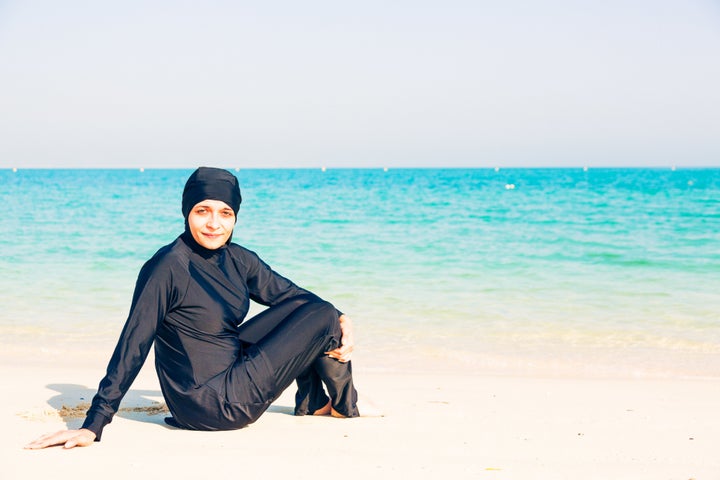 A young woman wearing a burkini on a beach in Dubai (file picture)