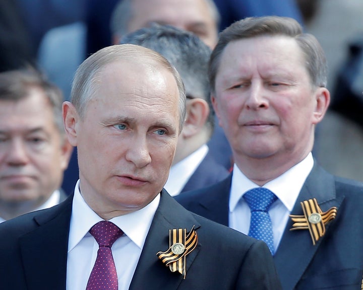 Russian President Vladimir Putin says his long-time ally, Sergei Ivanov, right, had asked to step down.