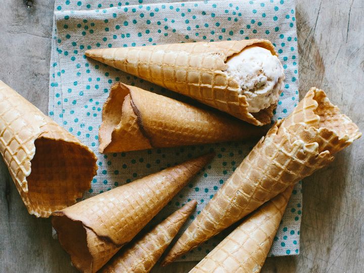 A bunch of waffle cones laid out.