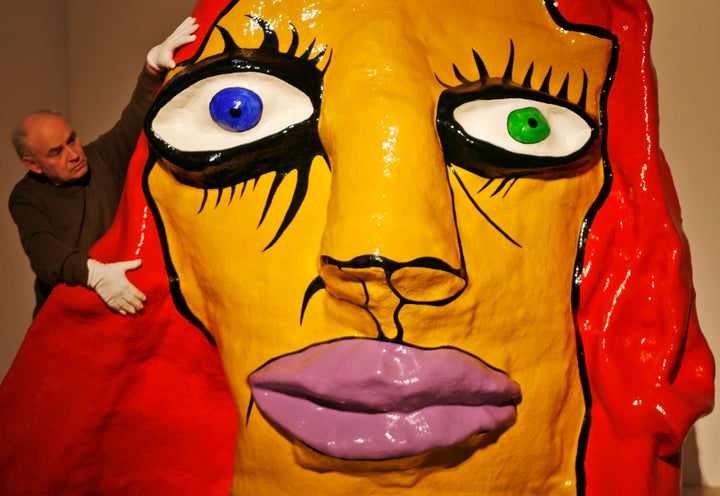 Museum worker Rainer Hinriksen adjusts the sculpture "Le Temoin" (The Witness) by French artist Niki de Saint Phalle (1930-2002) in the museum at Gottorf Castle in Schleswig, northern Germany, on Thursday, Feb.19, 2009.