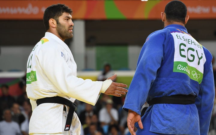 Israel's Or Sasson, left, attempts to shake the hand of Egypt's Islam El Shehaby after their men's +100kg judo match on Friday.