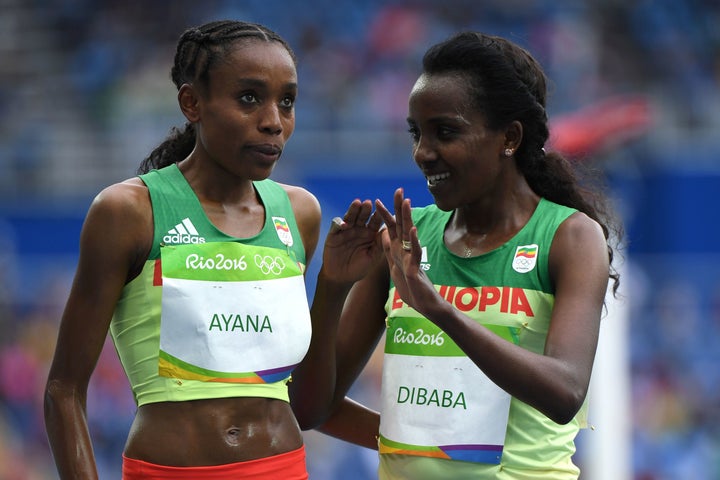 Ayana, left, celebrates with teammate Tirunesh Dibaba after they won gold and bronze respectively in the women's 10,000 meters.