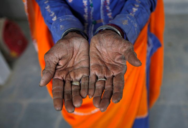 Radha, 75, a vegetable vendor poses with her hands after she got her fingerprint scanned for the Unique Identification (UID) database system at an enrolment centre at Merta district in the desert Indian state of Rajasthan February 22, 2013.