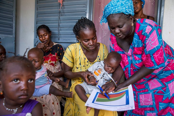 A community health worker in Kaolack, Senegal, providing women in her community counseling and postnatal care at her home. The women are also given counseling about reproductive health issues and family planning.