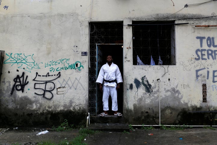 Popole Misenga, a refugee from the Democratic Republic of Congo and a judo athlete, poses at the entrance of his home in a slum in Rio de Janeiro, Brazil.