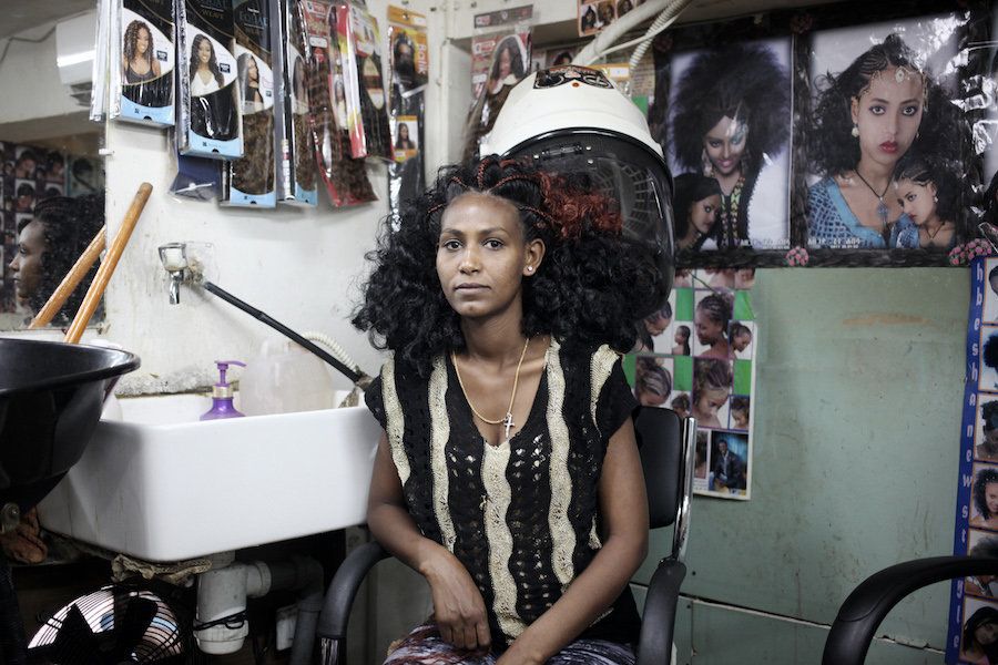 An Ethiopian woman after getting her hair done for Church near Levinsky Park, South Tel Aviv.