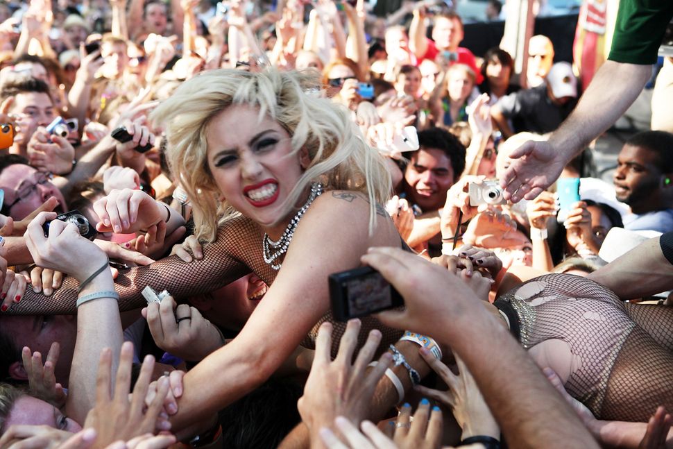 Lady Gaga jumps into the crowd during the performance of Semi Precious Weap...