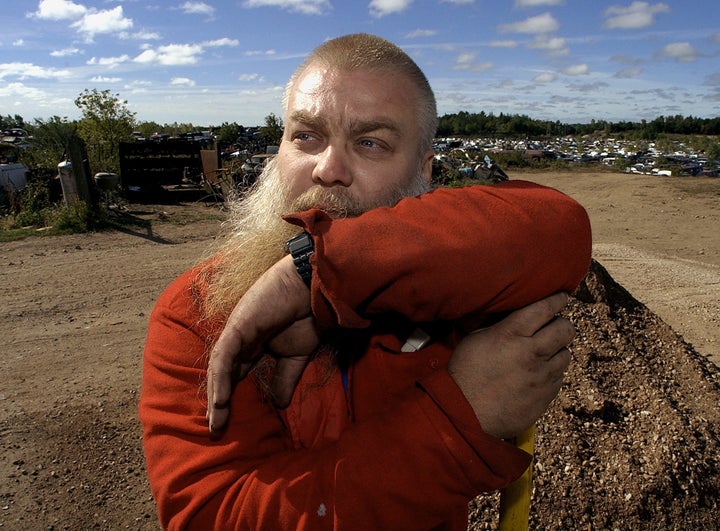 Steven Avery rests on the handle of a shovel after doing some work at the family salvage yard Thursday, Sept. 25, 2003.