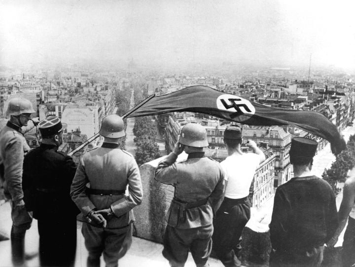 German occupation of Paris, World War II, June 1940. The Nazi flag flying from the Arc de Triomphe.