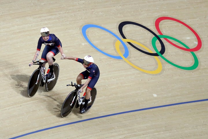 Katie Archibald of Great Britain, left, celebrates with teammate Laura Trott, right, after the women's team pursuit qualifying at the Rio Olympic Velodrome.