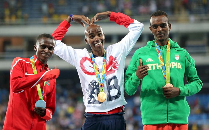 Paul Kipngetich Tanui (KEN) of Kenya, Mo Farah (GBR) of Britain and Tamirat Tola (ETH) of Ethiopia pose on podium.