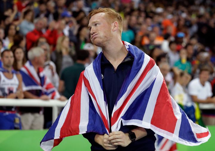 Britain's Greg Rutherford celebrates with the British flag after winning the bronze medal in the men's long jump final.