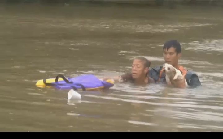 A woman and her dog are seen moments after they were pulled from a sinking car by this man in Baton Rouge.