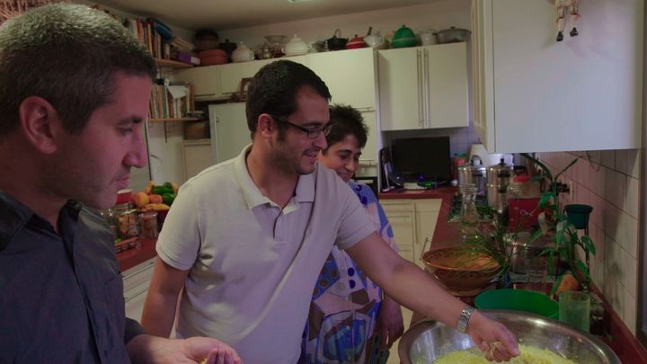 Chef Michael Solomontov in the kitchen with tour guideAvihai Tsabari in a scene from In Search of Israeli Cuisine