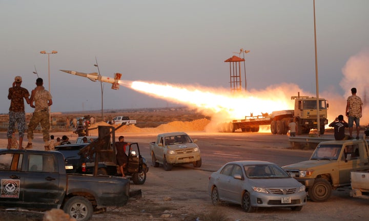 Fighters of Libyan forces allied with the U.N.-backed government fire a rocket at Islamic State fighters in Sirte, Libya, Aug