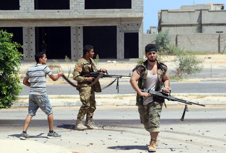 Forces loyal to Libya's UN-backed Government of National Accord (GNA), holding a position in al-Zaafaran neighbourhood, fire towards Islamic State group (IS) fighters' positions in residential district two on August 14, 2016 in Sirte