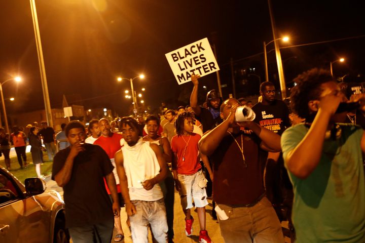 Protesters marched on Sunday following the police shooting of an armed man in Milwaukee.