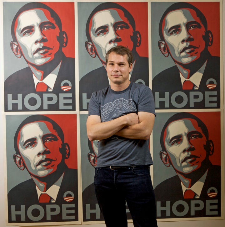 Shepard Fairey poses in front of his art in January 2009.