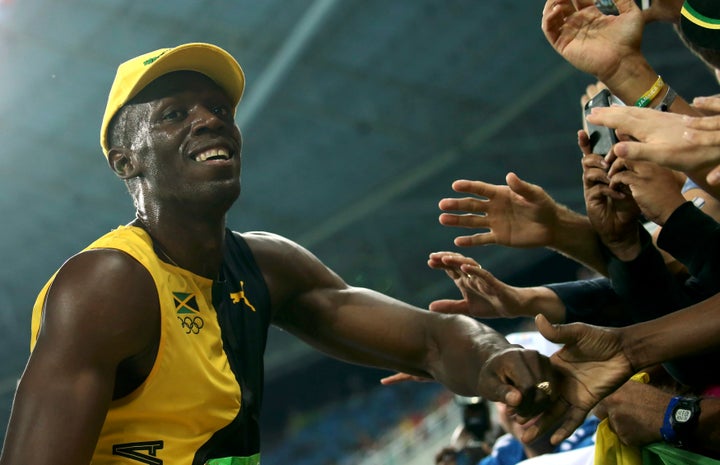 Usain Bolt celebrates another gold in the 100-meters.