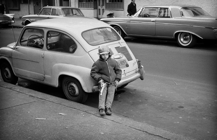 Greenwich Village street scene: A boy rests after playing "good guys vs. bad guys." (Jim Marshall, 1963.)