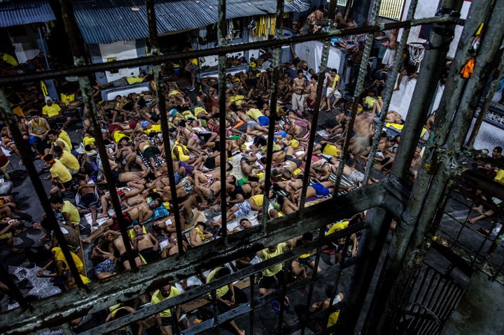This picture taken on July 21, 2016, shows inmates sleeping at the open basketball court inside the Quezon City Jail in Manil