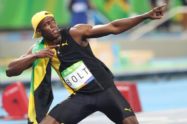 Usain Bolt of Jamaica strikes his 'Lightening Bolt' pose after winning the Men's 100m Final at the Olympic Stadium.