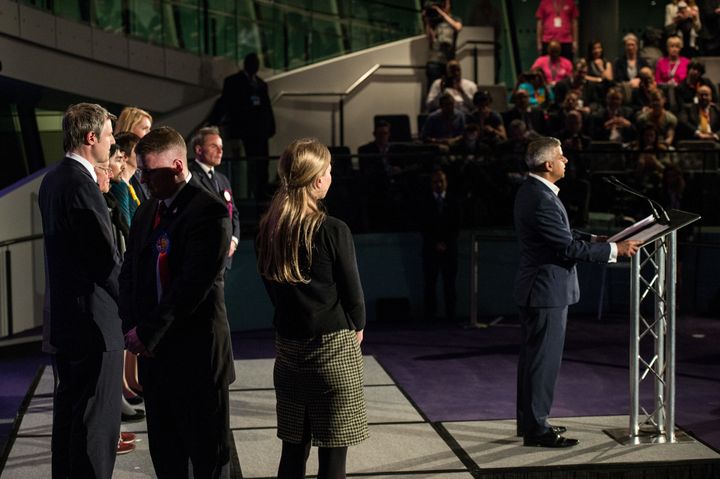 <strong>Paul Golding, turns his back Sadiq Khan of the Labour Party makes an acceptance speech as the new Mayor of London at City Hall on May 06.</strong>