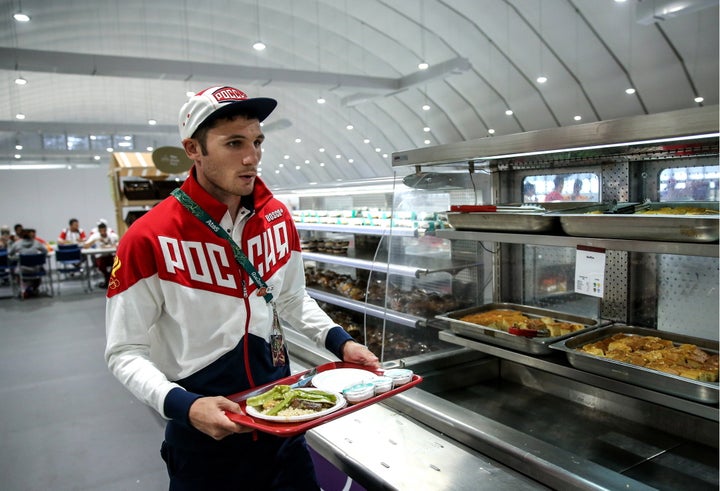 RIO DE JANEIRO, BRAZIL AUGUST 2, 2016: Russian boxer Andrei Zamkovoi having lunch in the canteen in the Olympic village ahead