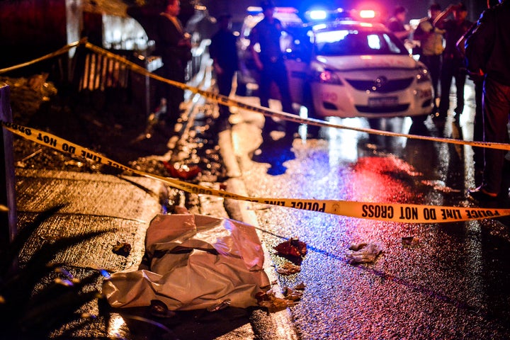 The corpse of a suspected drug pusher and victim of a vigilante-style execution lie along a street in Makati, Metro Manila, Philippines, August 9, 2016.