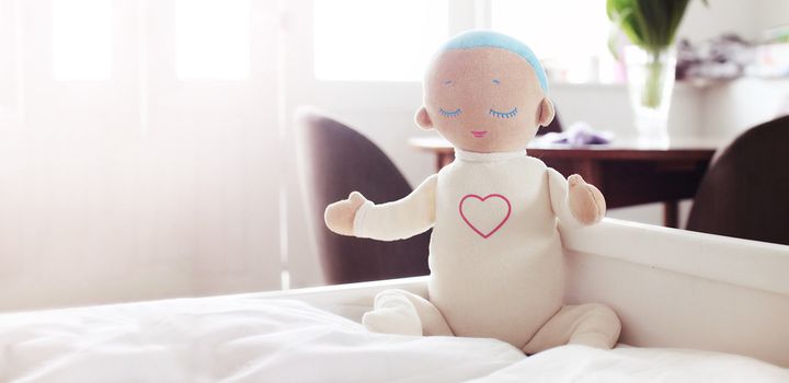 Straps hidden inside the Lulla doll can be used to secure the doll to a crib, bed, shelf or car seat, so that younger children can safely sleep near the doll.