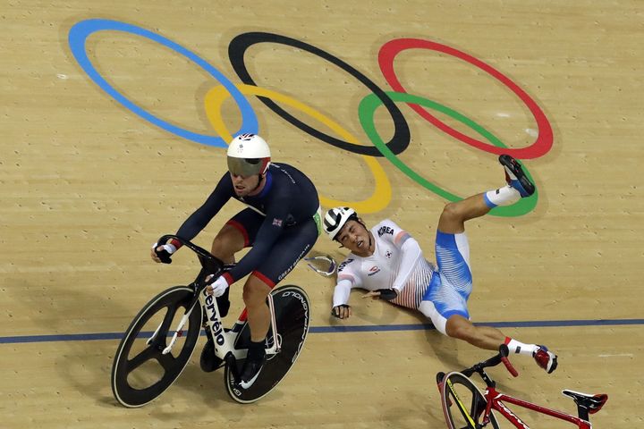 Park Sang-hoon of South Korea, right, falls near Mark Cavendish of Britain, left, during the men's cycling omnium points race.