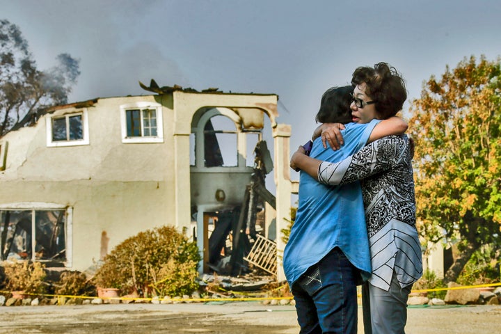 Aurora Harris Heller, 62, left, comforts the owner of a house destroyed in Sand Fire in Santa Clarita, July 26, 2016 .