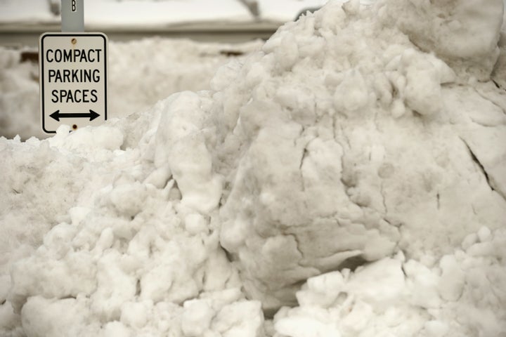 Plowed piles of snow block parking spaces on the roof of a parking garage in Washington, DC, Jan. 26, 2016.