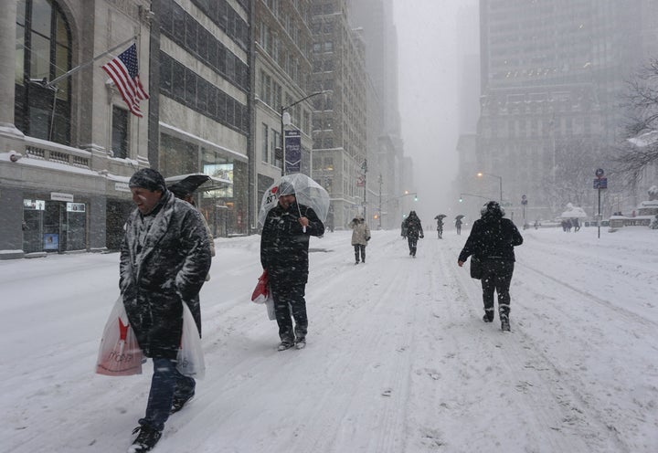 People walk on snow as winter storm Jonas hits New York, Jan. 23, 2016.