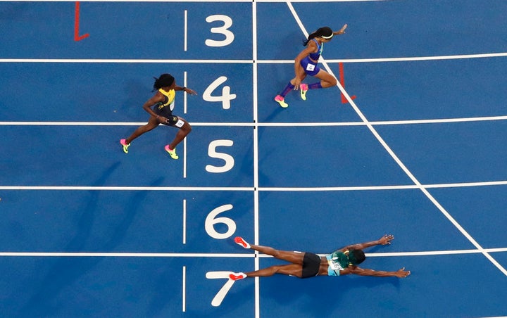 Felix, in lane four, crosses the finish line just behind Shaunae Miller of the Bahamas, who dove for the gold after a close race.