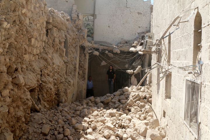 Residents inspect their damaged homes after an airstrike on the rebel-held Old Aleppo, Syria August 15, 2016.