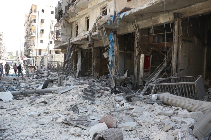 People inspect the area after warcrafts belonging to Syrian and Russian army hit the residential area at Tarik al-Bab neighbo