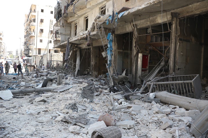 People inspect the area after warcrafts belonging to Syrian and Russian army hit the residential area at Tarik al-Bab neighborhood of Aleppo, Syria on August 16, 2016.