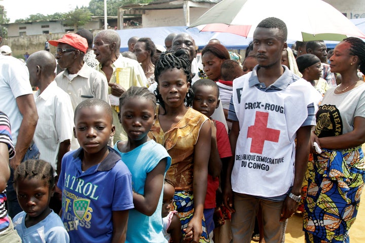 Congolese civilians queue at a soccer pitch to be vaccinated during an emergency campaign of vaccination against yellow fever