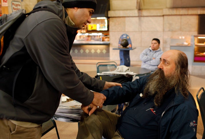 Boston Health Care for the Homeless Program street team member Dr. Patrick Perri examines the sore arm of John Matwichuk, who is homeless. The street team works to bring health care to Boston's chronically homeless, and to get those homeless to medical care.