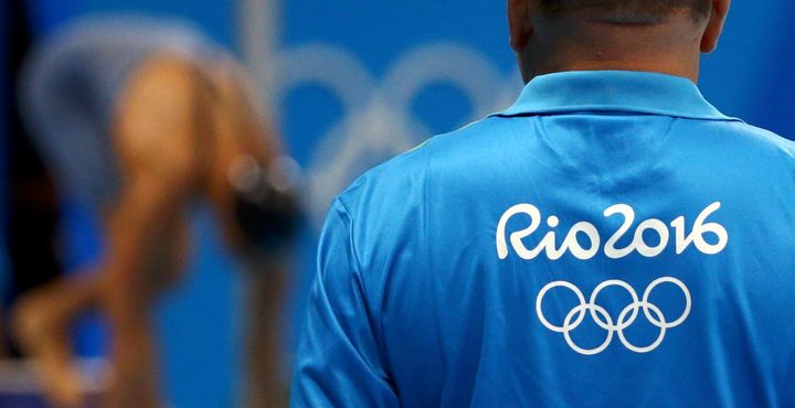 An unidentified Rio Olympics volunteer looks on at the aquatics center last week. 