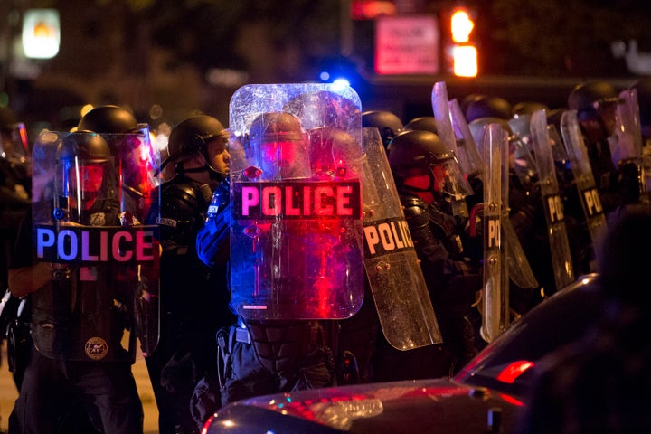 Police respond to a protest after rioters threw rocks and bottles in the unrest following a fatal police shooting in Milwaukee on Saturday.