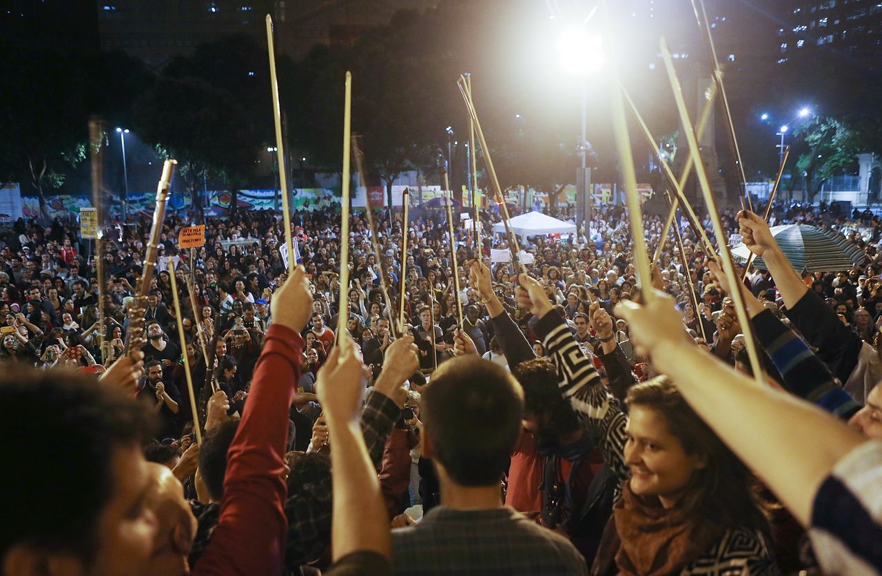 Musicians hold their bows after performing at a rally protesting Temer in Rio de Janeiro on June 10.
