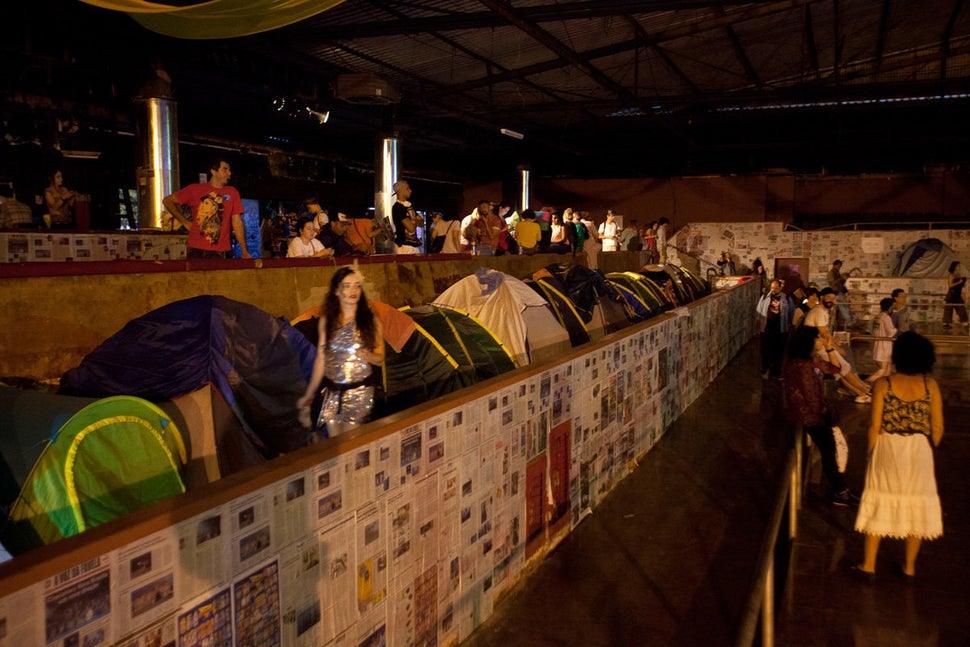 People walk past Ocupa MinC tents in Canecão in Rio de Janeiro on Aug. 4.