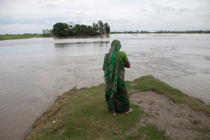 A flood affected woman stands on a highland at Guthail, Jamalpur earlier this month. According to the Bangladesh Disaster Man