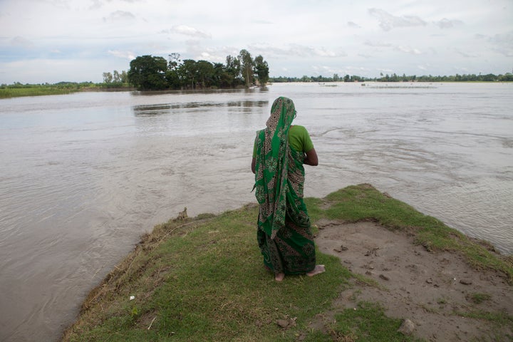 A flood affected woman stands on a highland at Guthail, Jamalpur earlier this month. According to the Bangladesh Disaster Management Bureau around 1.5 million people have been affected by this year's flood.