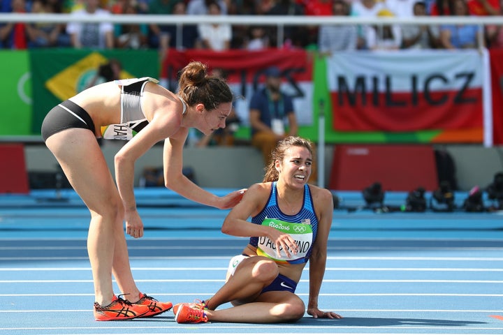 Abbey D'Agostino (R) is assisted by Nikki Hamblin